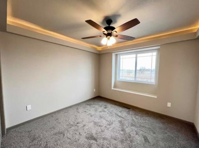 906 Top O Hill Ave, Hill City, SD 57745 - empty room featuring carpet floors, a tray ceiling, and ceiling fan