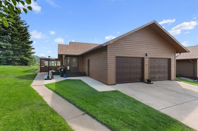 view of front facade featuring a garage, a shingled roof, and a front lawn