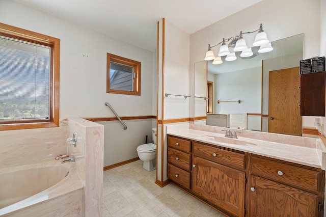 bathroom with vanity, toilet, tile patterned floors, and a tub to relax in