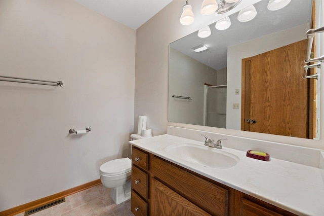 bathroom featuring tile patterned floors, toilet, and vanity