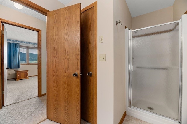 bathroom featuring tile patterned flooring and an enclosed shower