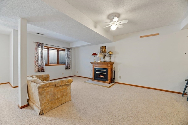 living room with a textured ceiling, ceiling fan, and carpet flooring