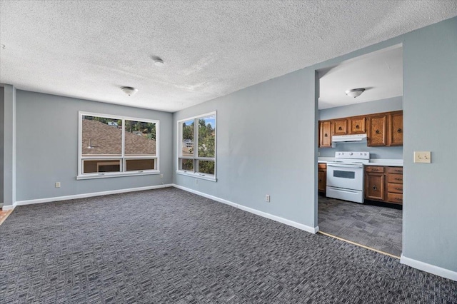 unfurnished living room with a textured ceiling and dark colored carpet