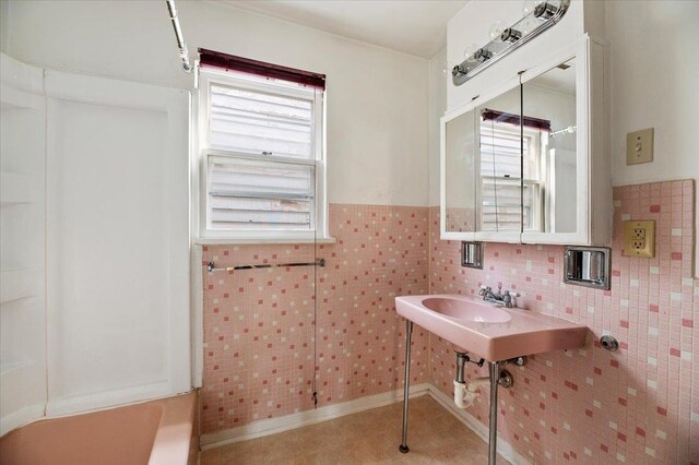 bathroom with tile patterned floors and tile walls