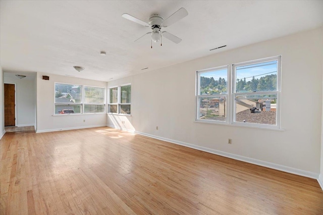 unfurnished living room with plenty of natural light, ceiling fan, and light hardwood / wood-style flooring