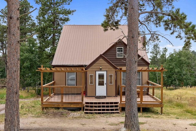 chalet / cabin with metal roof and a wooden deck