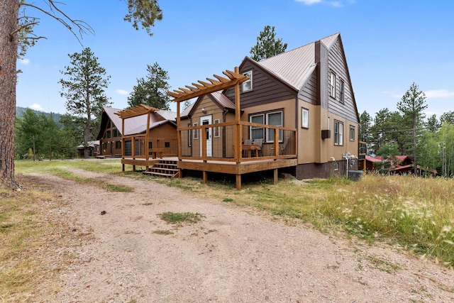 view of front of property with a deck, a pergola, and metal roof