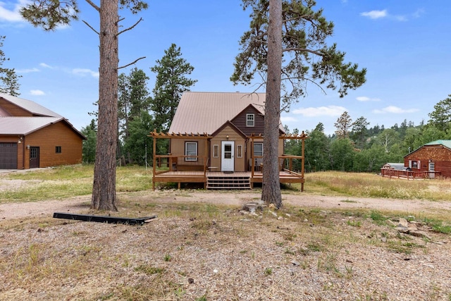 view of front of house featuring a wooden deck and metal roof