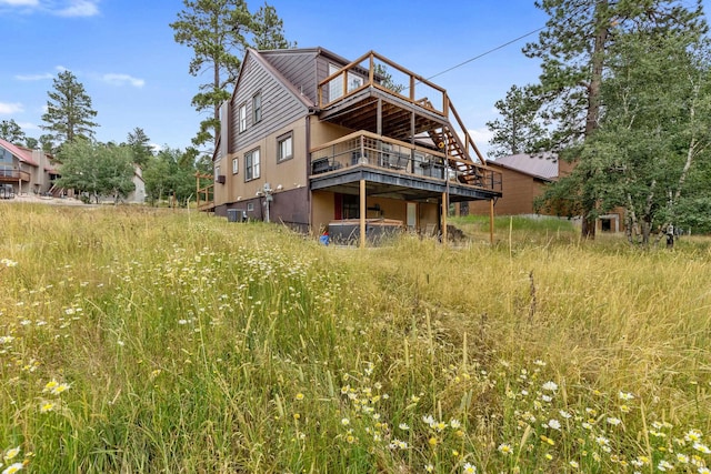 rear view of house featuring a wooden deck