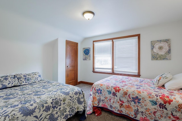 carpeted bedroom featuring baseboards