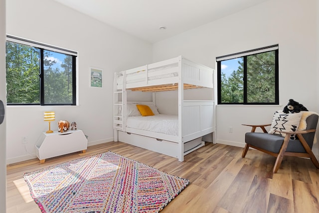 bedroom featuring multiple windows and light wood-type flooring