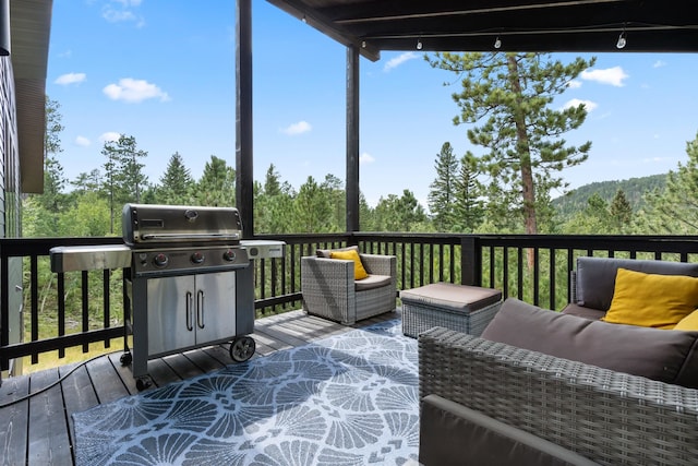 wooden terrace with a grill