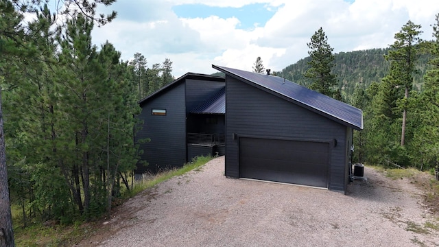 view of front of property featuring an outdoor structure and a garage