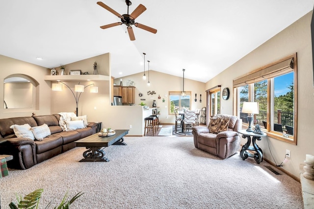 carpeted living room with high vaulted ceiling, baseboards, and a ceiling fan