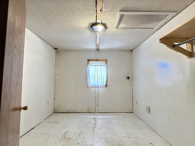 spare room featuring unfinished concrete flooring and a textured ceiling