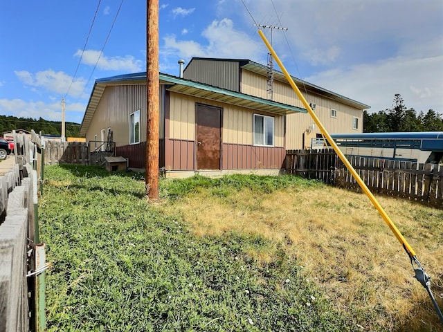 view of side of home with a fenced backyard