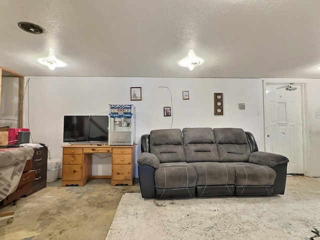 living area with concrete floors, a textured ceiling, and ceiling fan