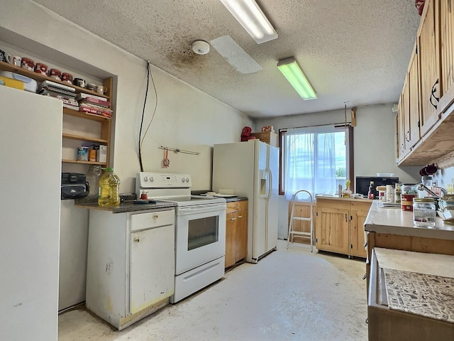 kitchen featuring white appliances, concrete flooring, and a textured ceiling