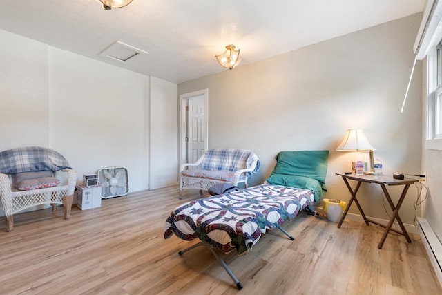 living area featuring light hardwood / wood-style floors and baseboard heating