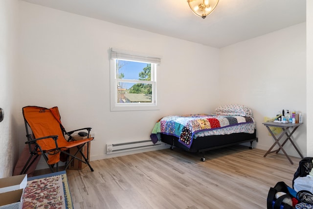 bedroom featuring light hardwood / wood-style floors and a baseboard radiator