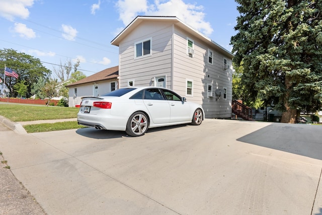 view of property exterior with a lawn