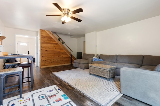 living room with ceiling fan and dark wood-type flooring