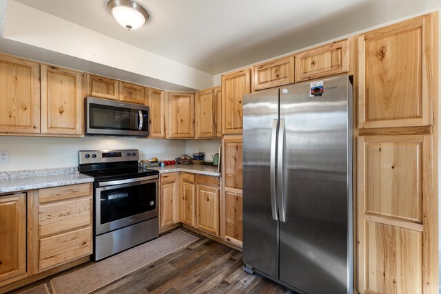 kitchen with appliances with stainless steel finishes, dark wood-type flooring, and light brown cabinets