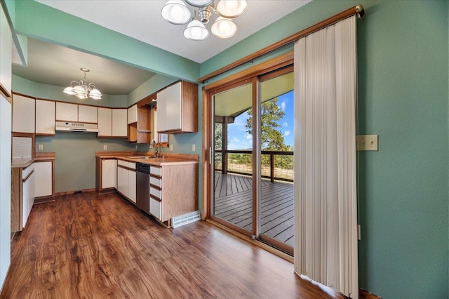 kitchen with dishwasher, an inviting chandelier, ventilation hood, dark wood-type flooring, and hanging light fixtures