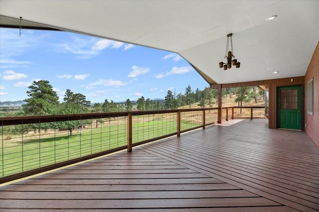 wooden terrace featuring a lawn