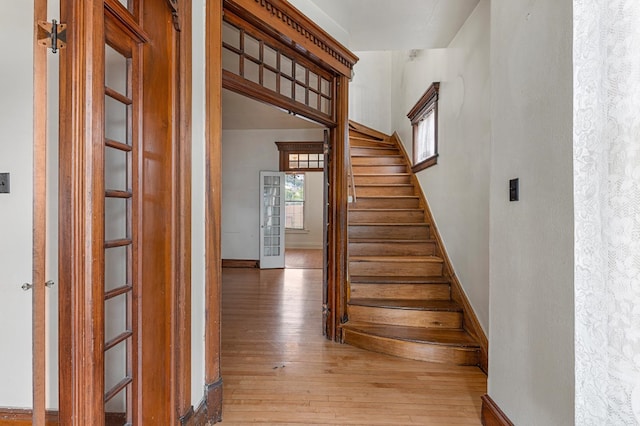 staircase with hardwood / wood-style flooring