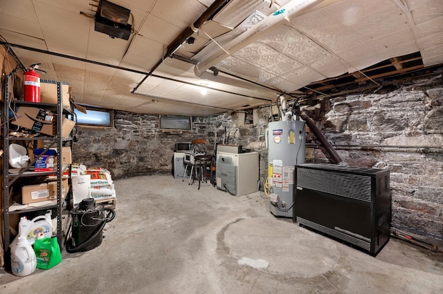 basement featuring gas water heater and heating unit