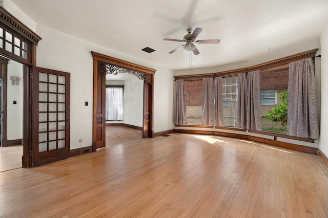 spare room featuring light hardwood / wood-style flooring and ceiling fan