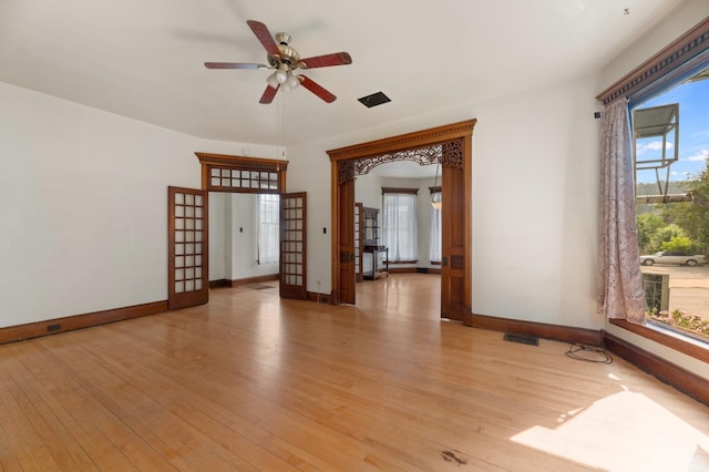 empty room with ceiling fan and light hardwood / wood-style flooring