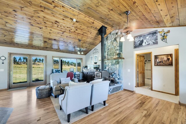 living room featuring wood ceiling, a wall mounted AC, high vaulted ceiling, and light hardwood / wood-style floors