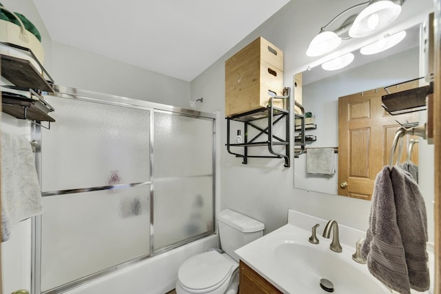 full bathroom with vanity, toilet, and bath / shower combo with glass door