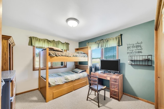 carpeted bedroom featuring baseboards