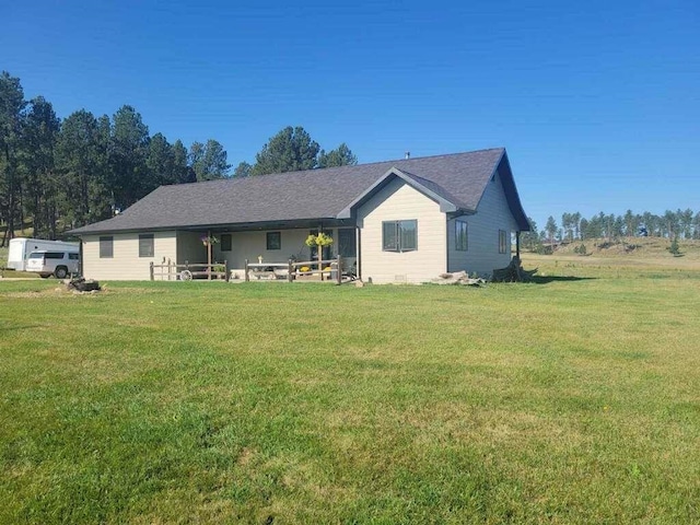 back of house with a yard