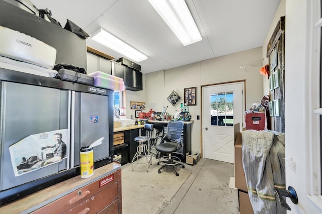 home office with concrete flooring