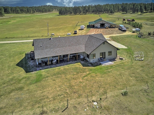 birds eye view of property with a rural view and a wooded view