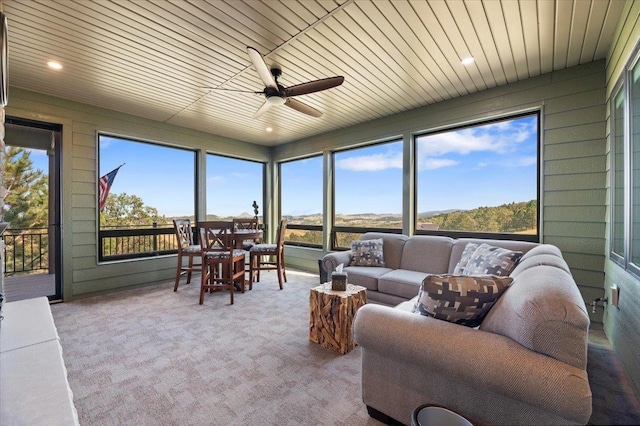 sunroom featuring wooden ceiling and ceiling fan