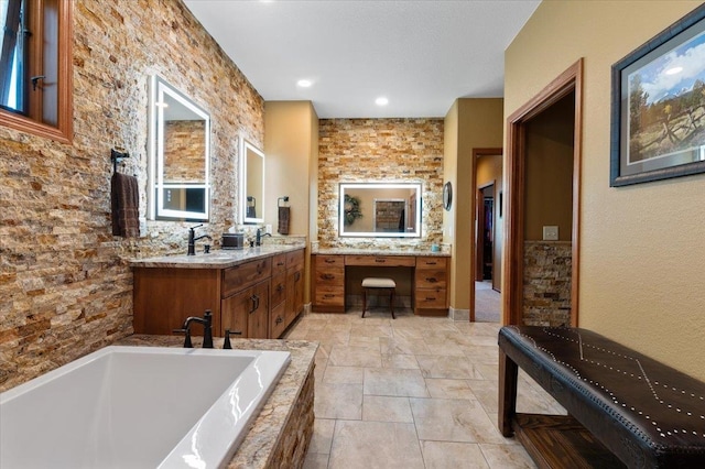 bathroom with vanity and tiled bath