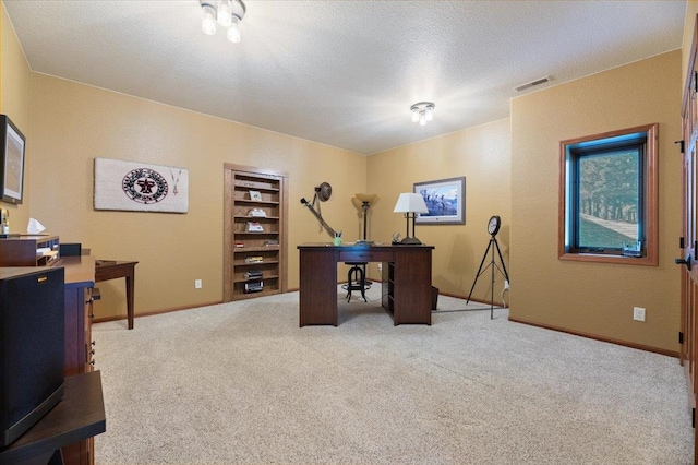 office area with light carpet and a textured ceiling