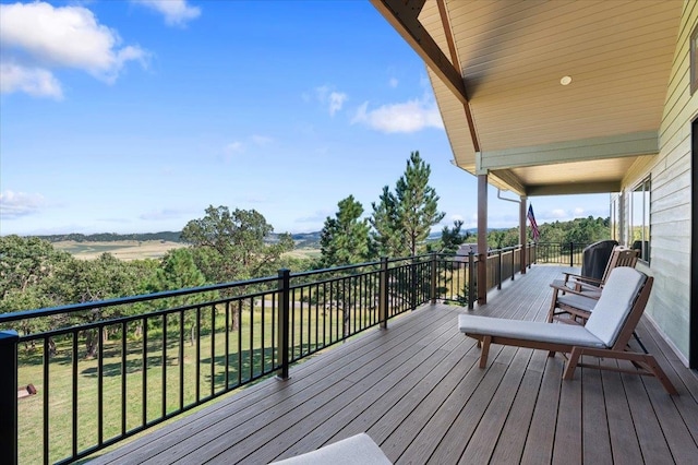 wooden terrace featuring a lawn