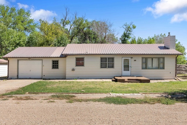 ranch-style house featuring a garage and a front yard