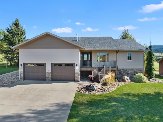 view of front of home with a garage, a front yard, and a porch