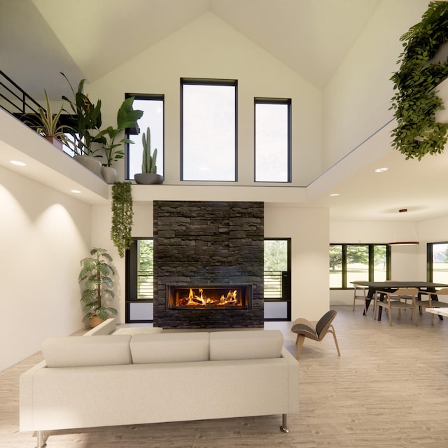 living room featuring a high ceiling, wood-type flooring, and a fireplace