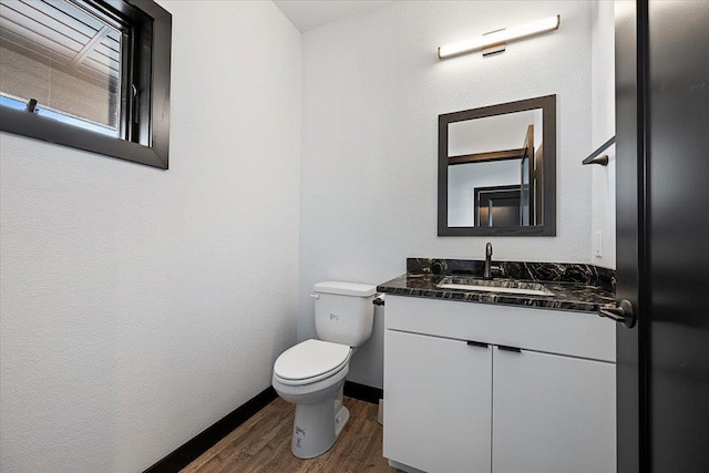 bathroom with vanity, hardwood / wood-style flooring, and toilet