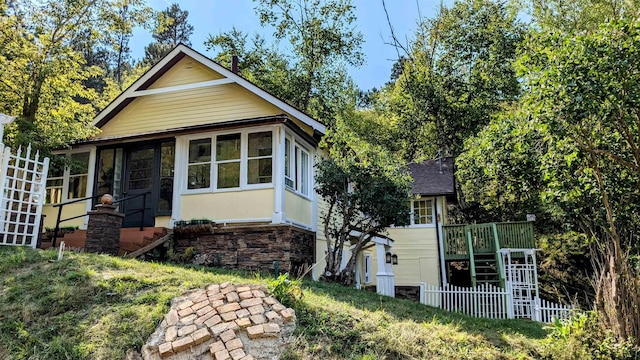 42 Wabash Ave, Deadwood, SD 57732 - view of front of house featuring stone siding, a sunroom, and stairs