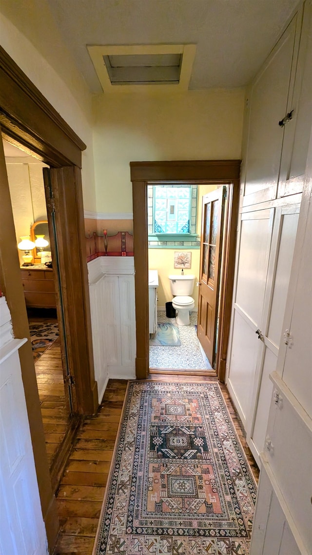 corridor featuring dark hardwood / wood-style floors