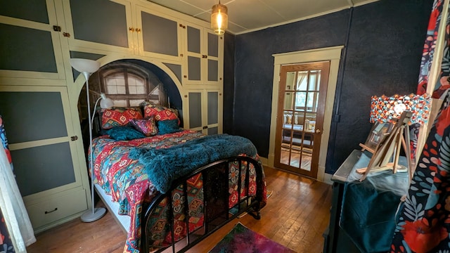 bedroom with hardwood / wood-style flooring